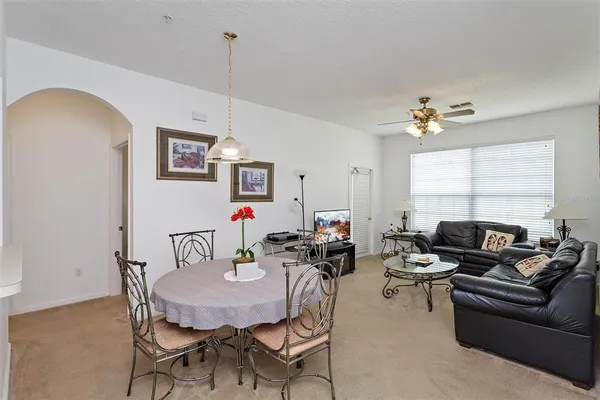 a living room with furniture a chandelier and a window
