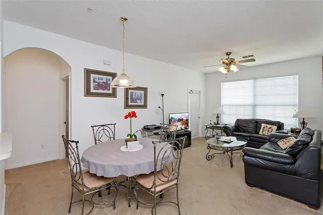 a living room with furniture a chandelier and a window