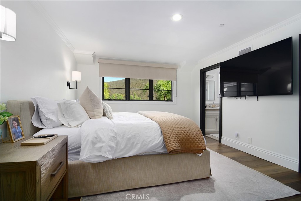 4947 Summit View Drive Westlake Village, CA 91362 - Photo 28 of 61 a bedroom with a bed and a flat screen tv