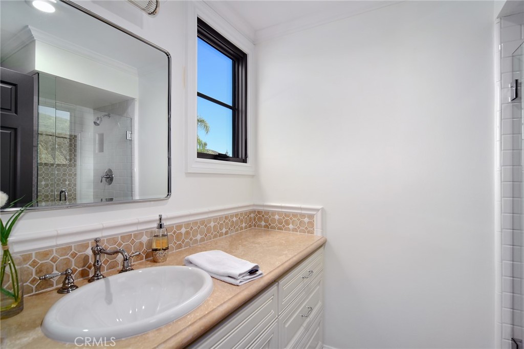 4947 Summit View Drive Westlake Village, CA 91362 - Photo 29 of 61 a bathroom with a granite countertop sink and a mirror