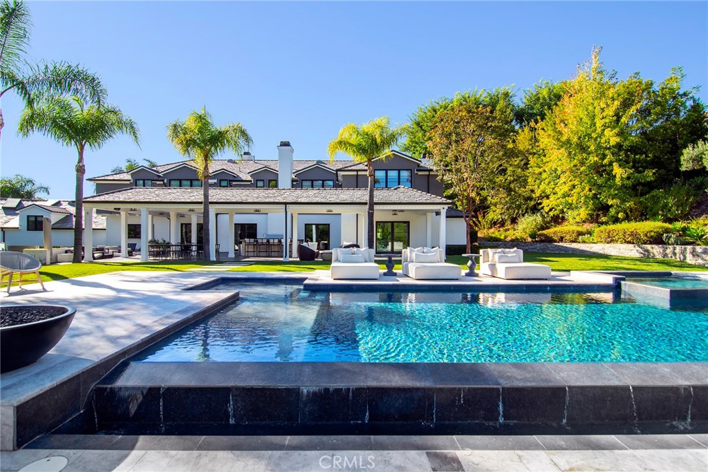 4947 Summit View Drive Westlake Village, CA 91362 - Photo 37 of 61 a view of a swimming pool with lawn chairs and plants
