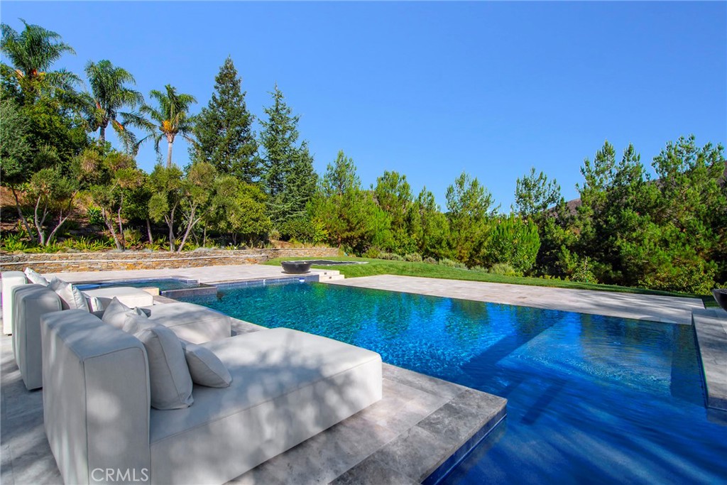 4947 Summit View Drive Westlake Village, CA 91362 - Photo 38 of 61 a view of a swimming pool with an outdoor space and seating area