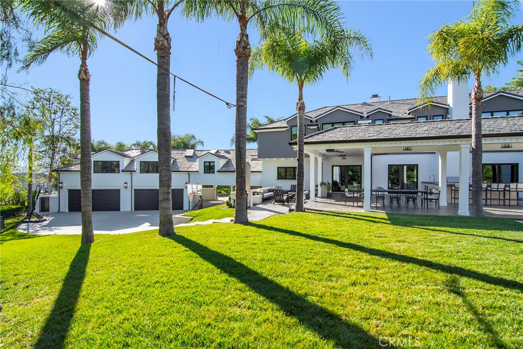 4947 Summit View Drive Westlake Village, CA 91362 - Photo 42 of 61 a view of a swimming pool with a table and chairs