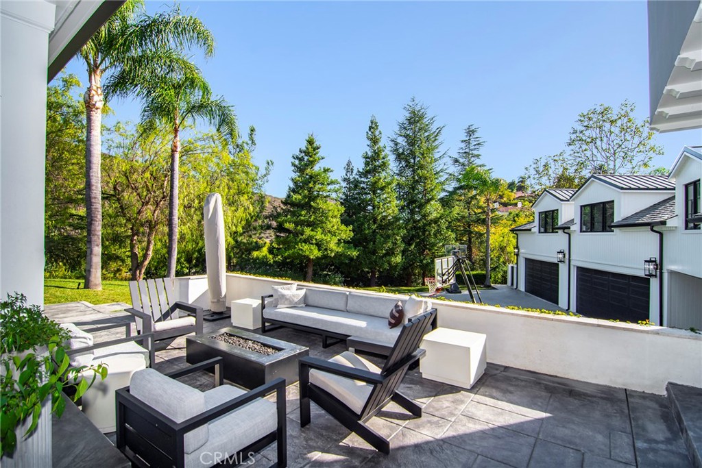 4947 Summit View Drive Westlake Village, CA 91362 - Photo 45 of 61 a view of a patio with couches table and chairs and potted plants