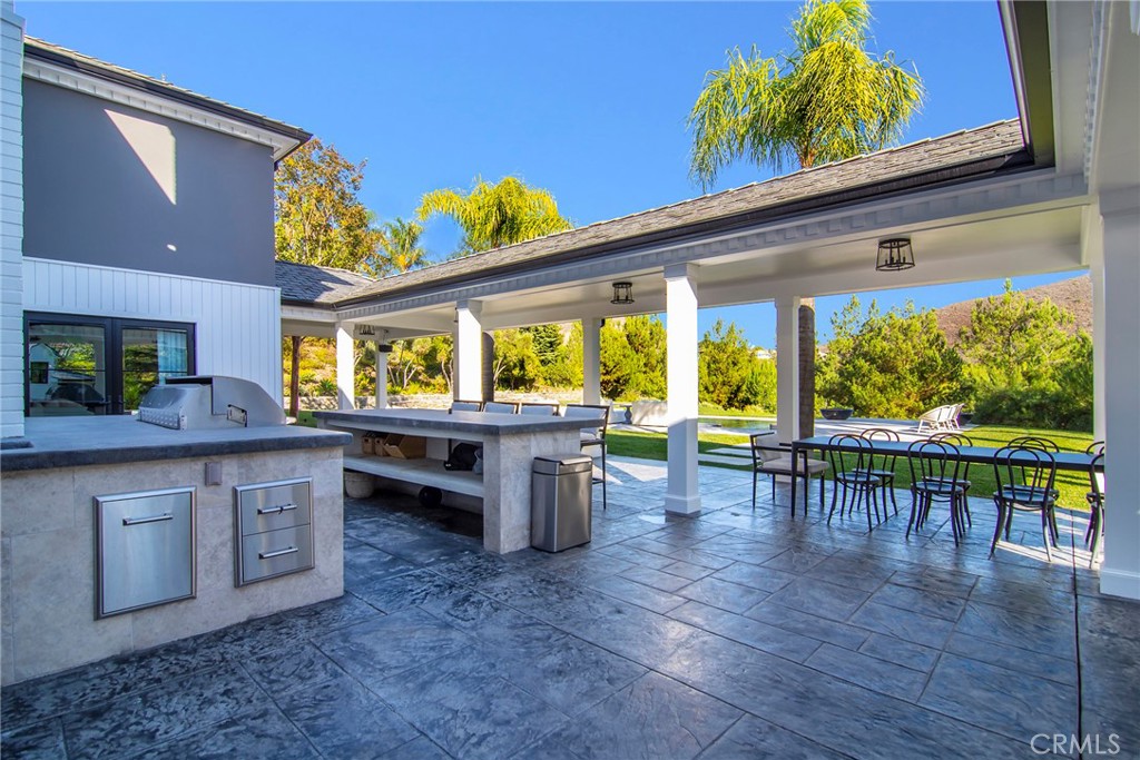 4947 Summit View Drive Westlake Village, CA 91362 - Photo 46 of 61 a kitchen view with wooden floor and outdoor seating