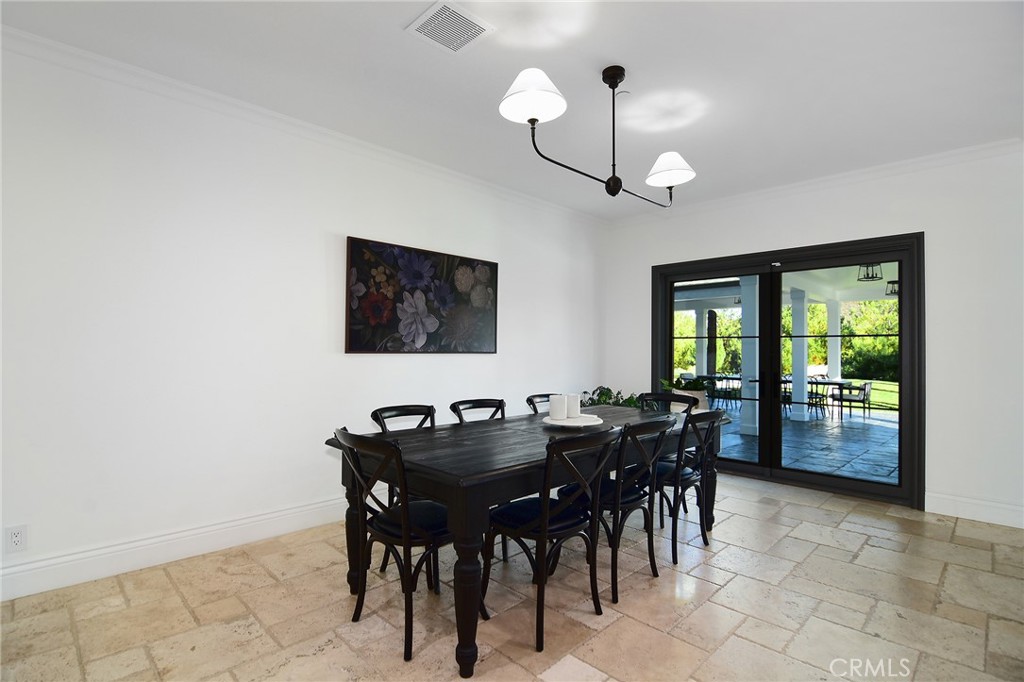 4947 Summit View Drive Westlake Village, CA 91362 - Photo 53 of 61 a view of a dining room with furniture and a chandelier