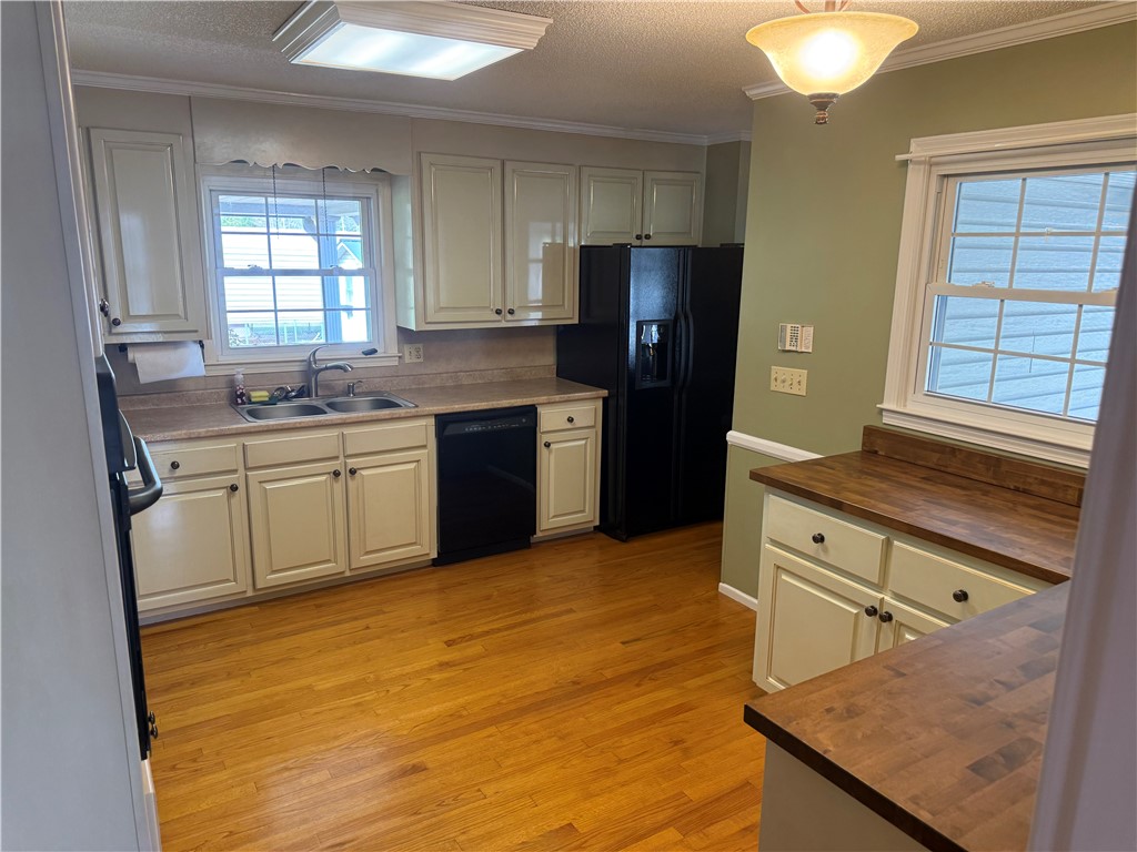 121 Nautical Way Anderson, SC 29625 - Photo 17 of 37 Natural light illuminates this kitchen, showcasing beautiful hardwood flooring and ample cabinet space.