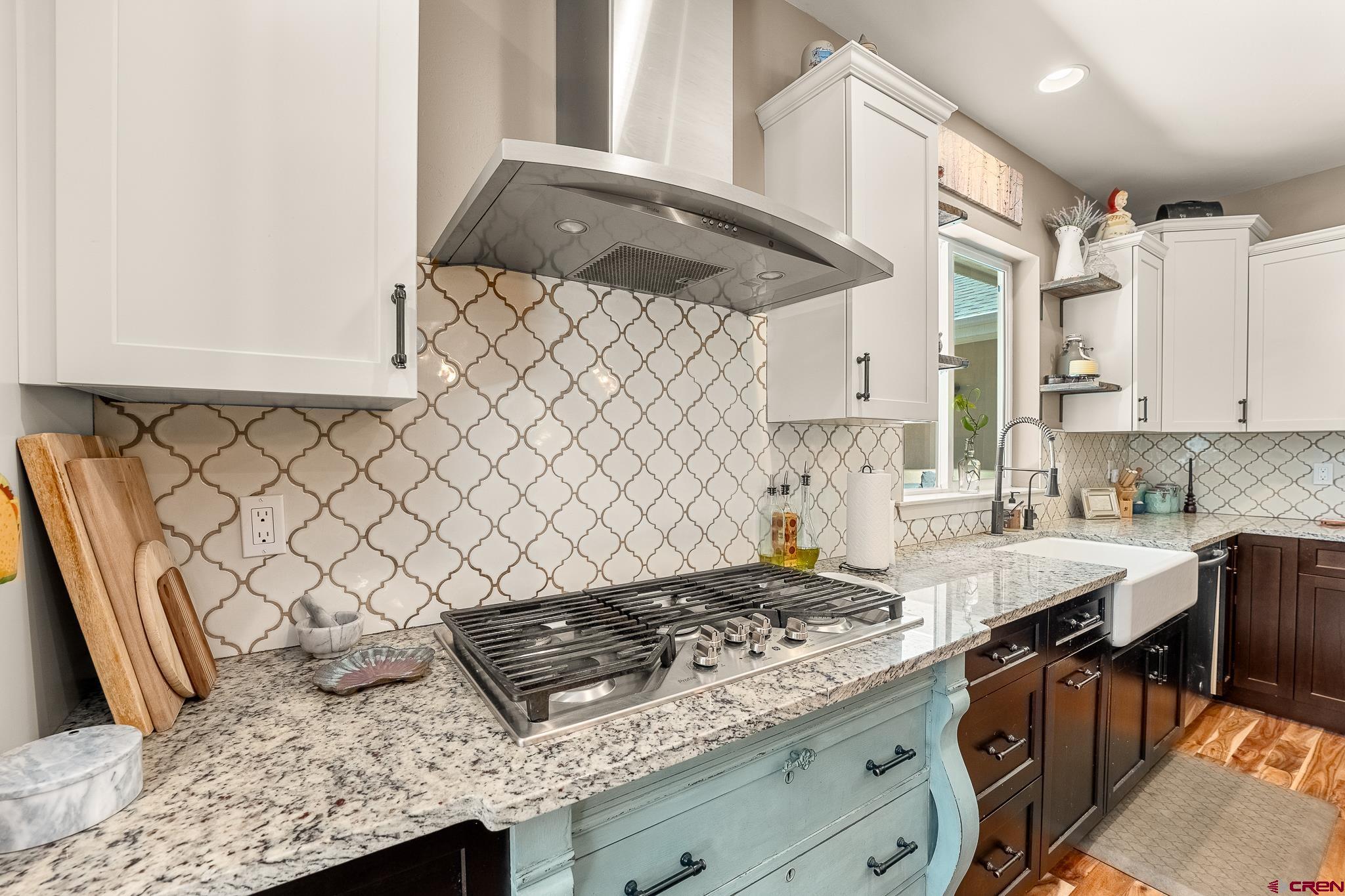 671 Sierra Circle Durango, CO 81301 - Photo 11 of 35 a kitchen with granite countertop a sink stove and cabinets