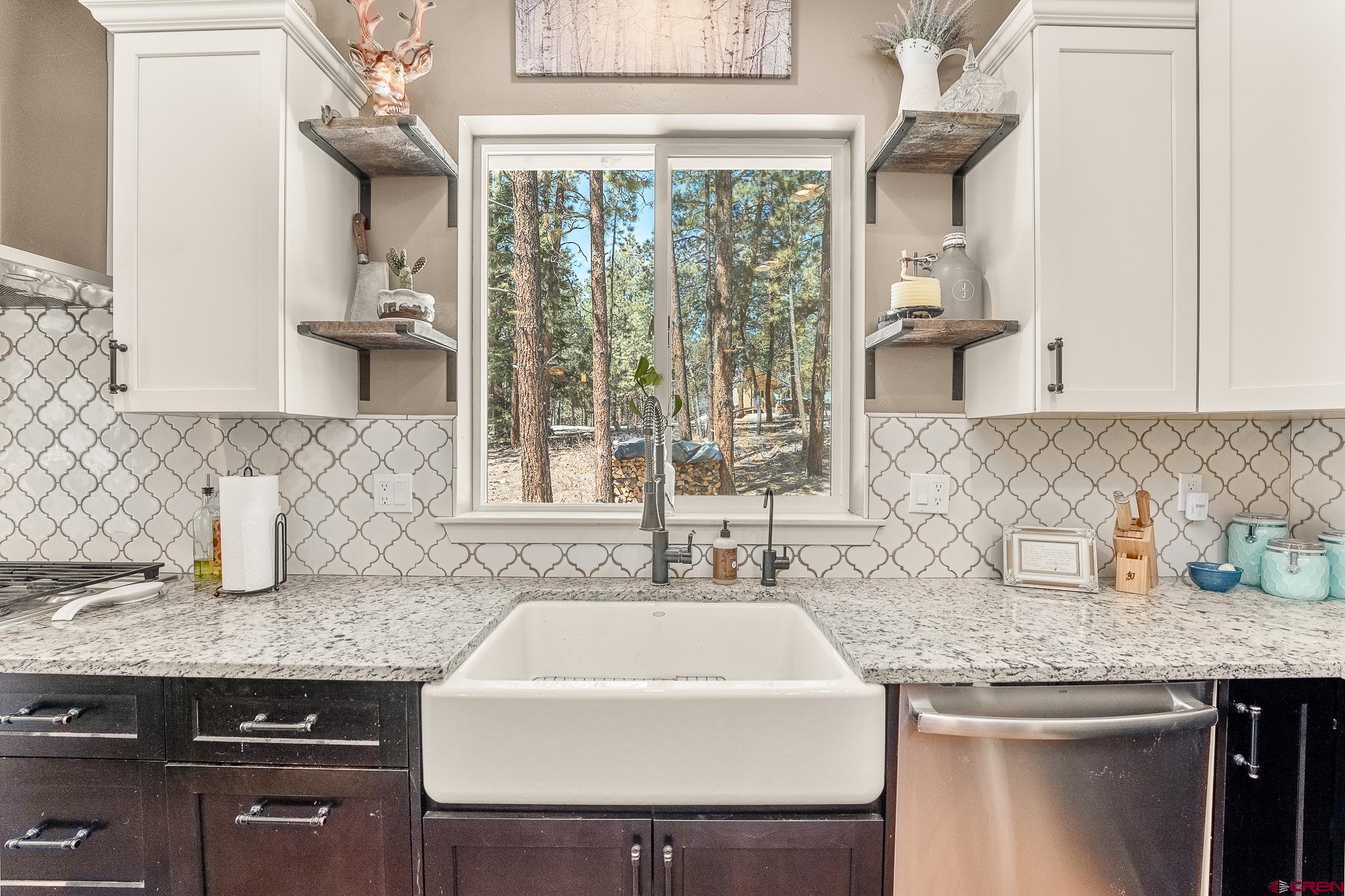 671 Sierra Circle Durango, CO 81301 - Photo 13 of 35 a kitchen with a sink a counter top space and cabinets