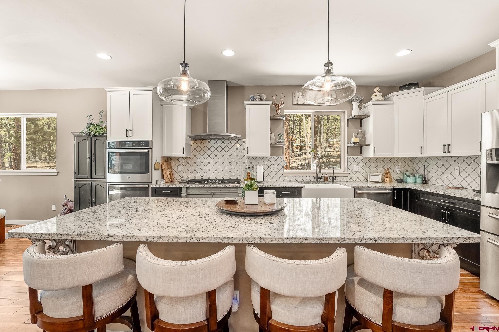 671 Sierra Circle Durango, CO 81301 - Photo 14 of 35 a kitchen with granite countertop a table and chairs in it