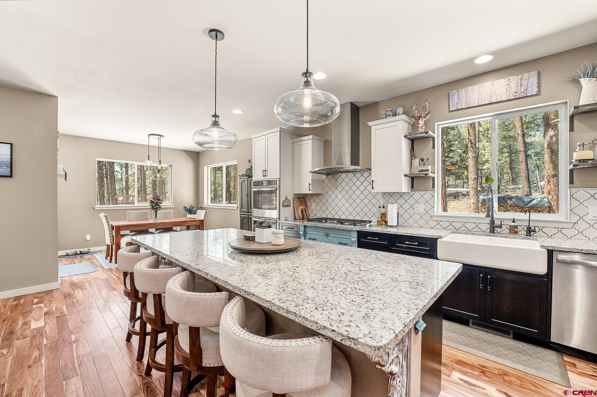 671 Sierra Circle Durango, CO 81301 - Photo 15 of 35 a kitchen with center island table and chairs