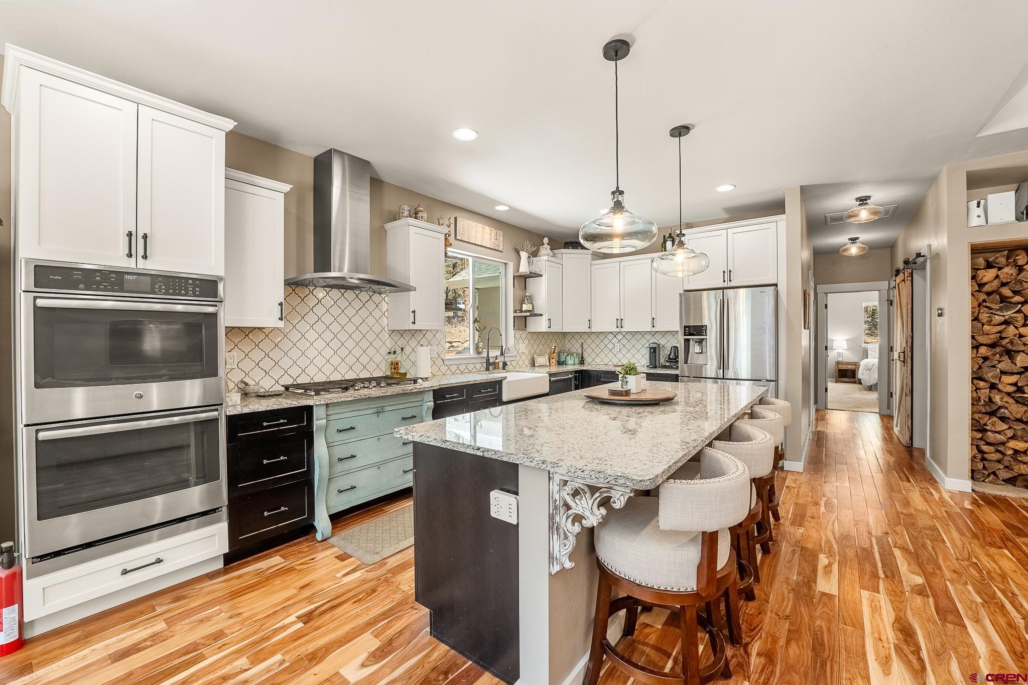 671 Sierra Circle Durango, CO 81301 - Photo 16 of 35 a kitchen with stainless steel appliances kitchen island granite countertop a sink stove and refrigerator