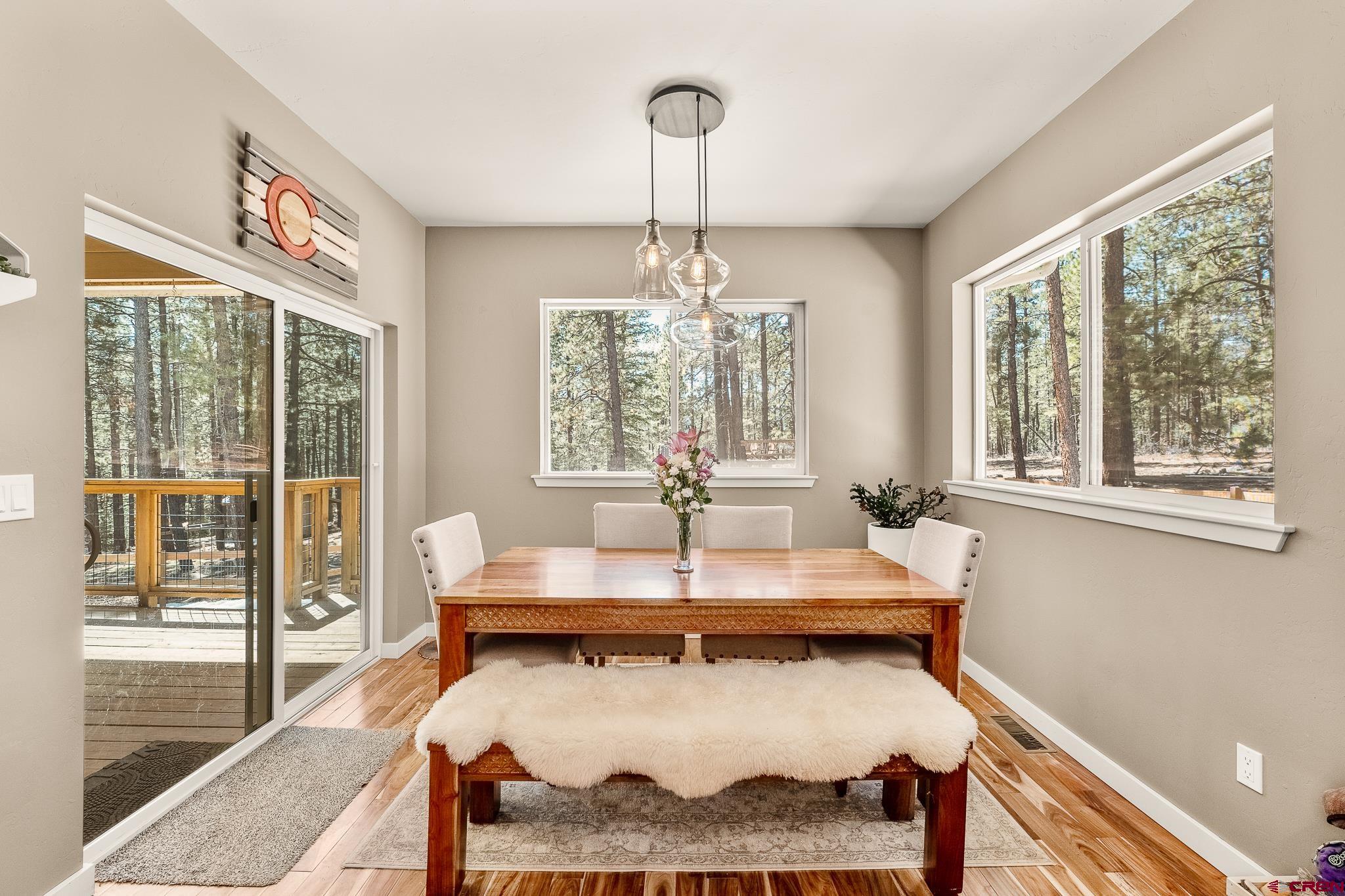 671 Sierra Circle Durango, CO 81301 - Photo 17 of 35 a living room with a table and a chandelier