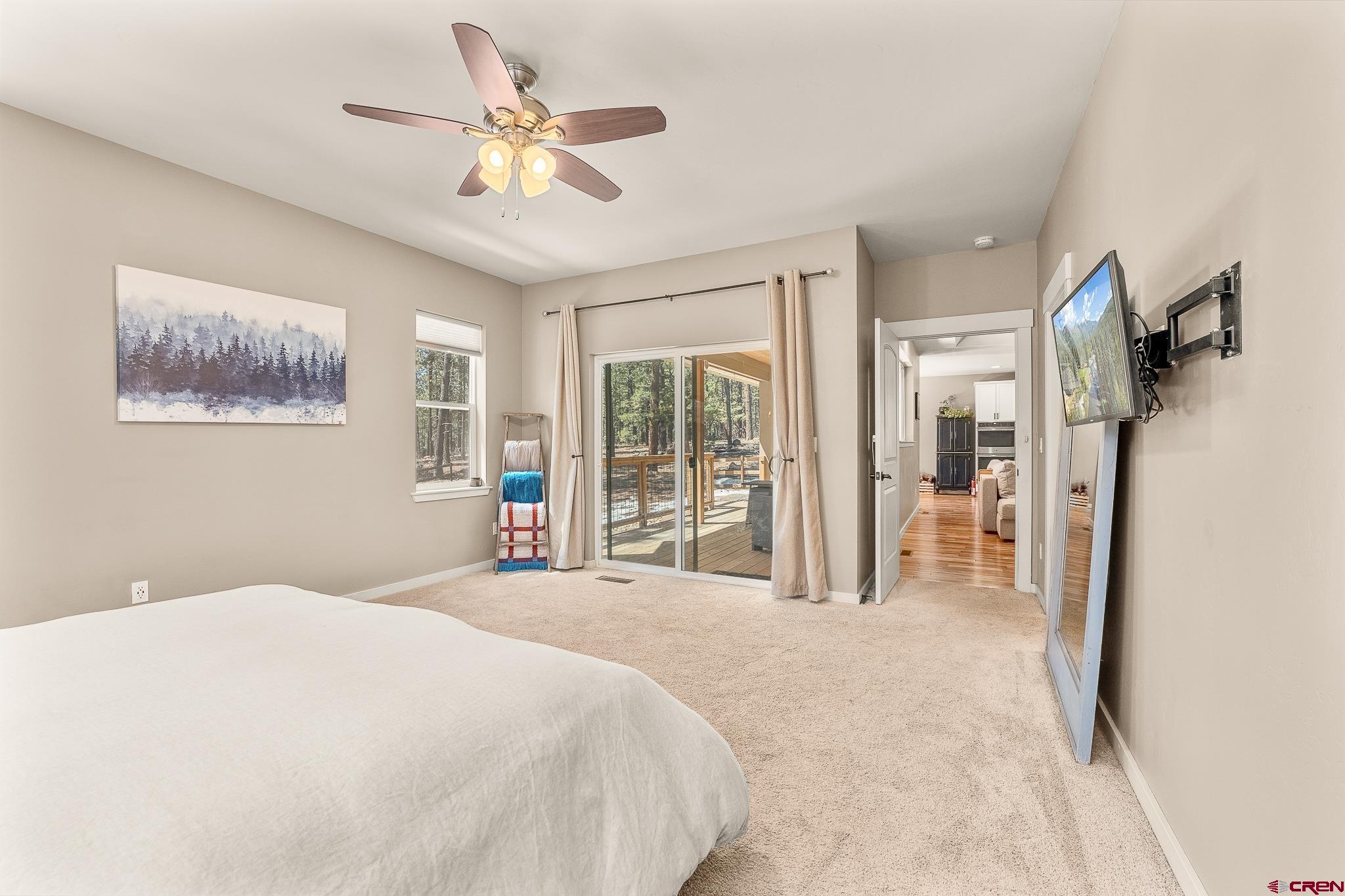 671 Sierra Circle Durango, CO 81301 - Photo 22 of 35 a bedroom with a large bed and a chandelier