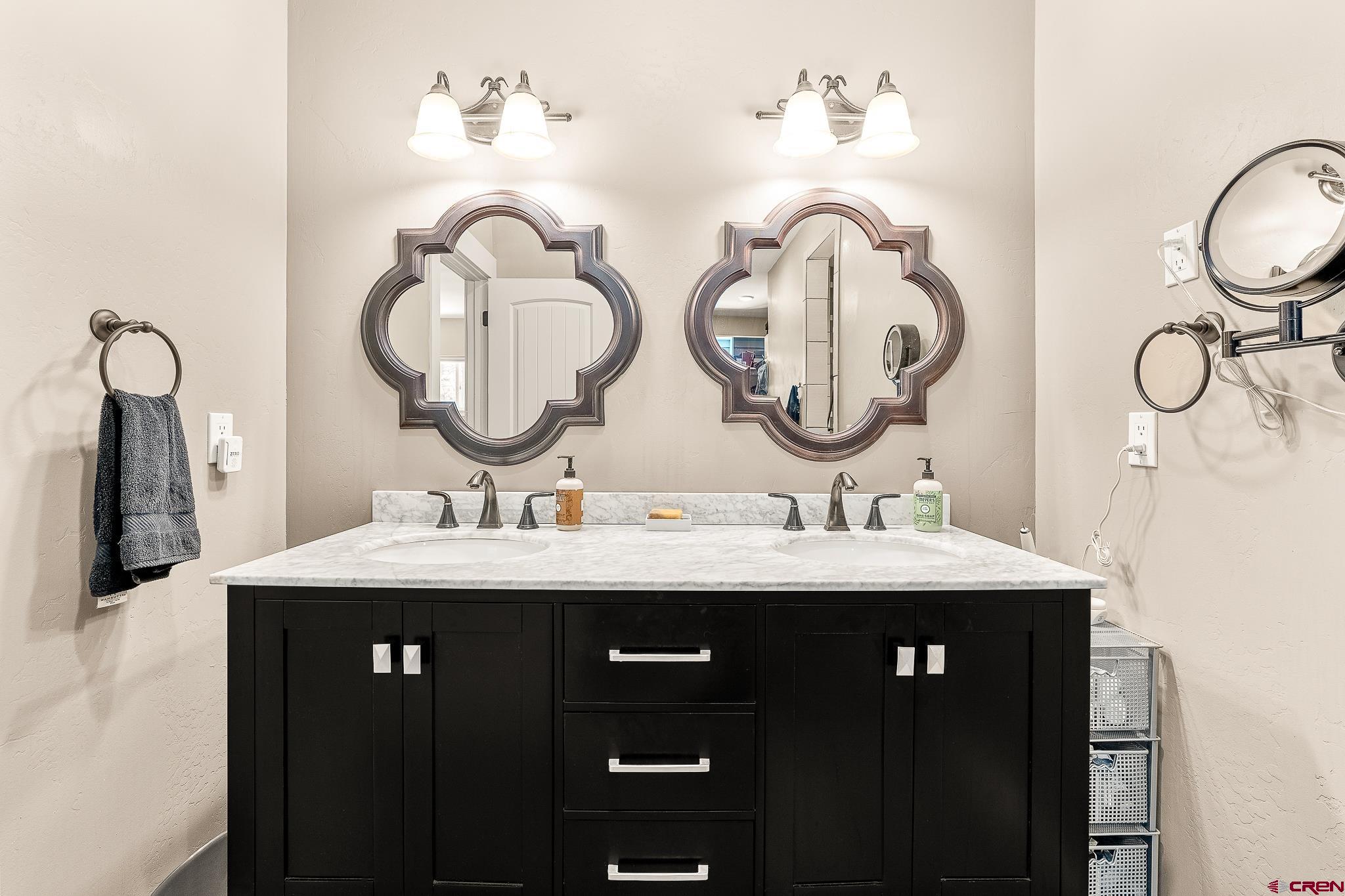 671 Sierra Circle Durango, CO 81301 - Photo 25 of 35 a bathroom with a sink and a mirror