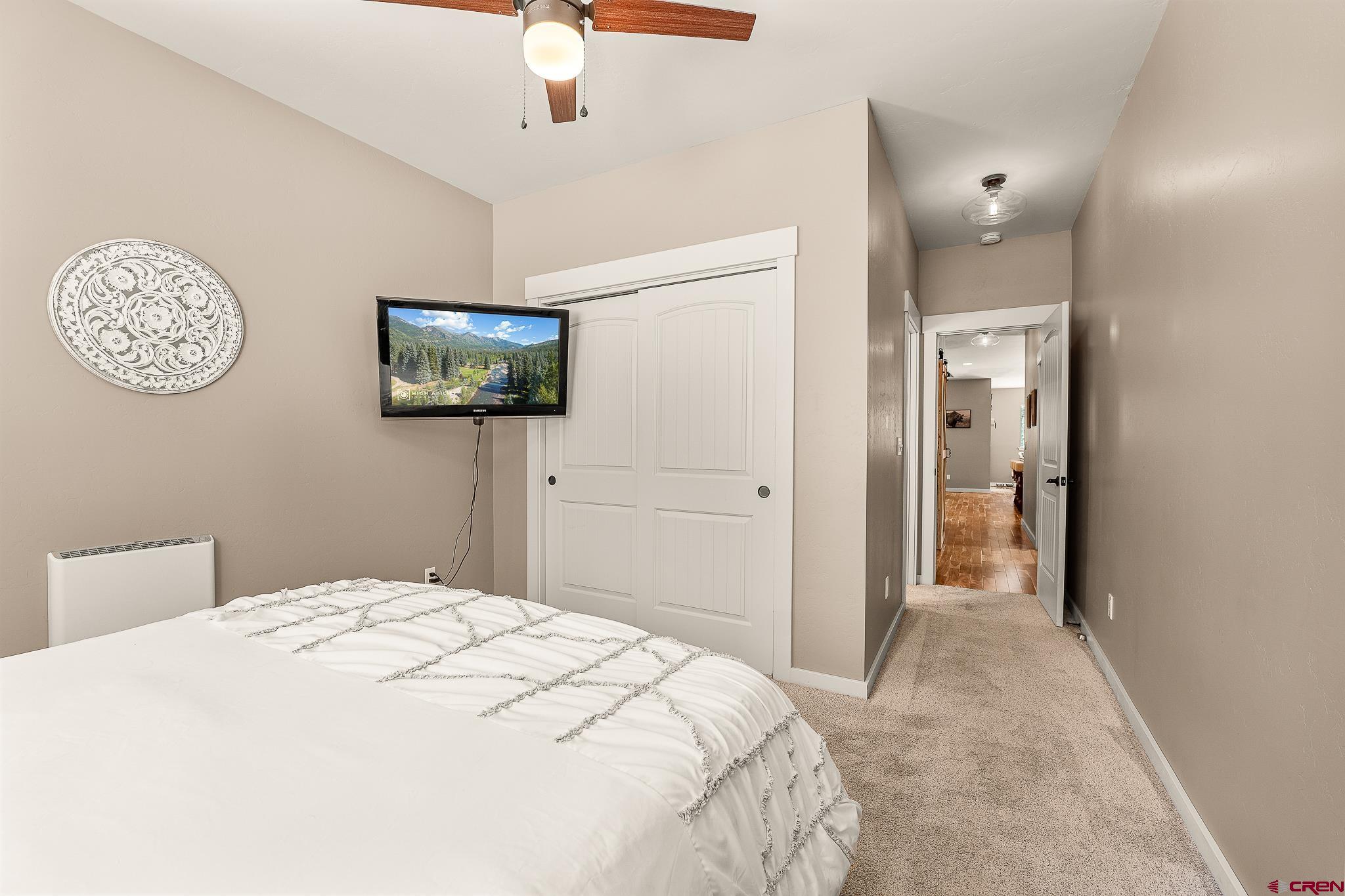 671 Sierra Circle Durango, CO 81301 - Photo 27 of 35 a bedroom with a bed and a chandelier