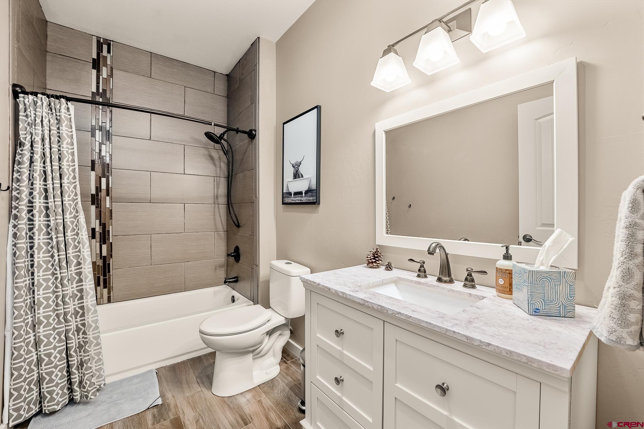 671 Sierra Circle Durango, CO 81301 - Photo 34 of 35 a bathroom with a sink a toilet and shower