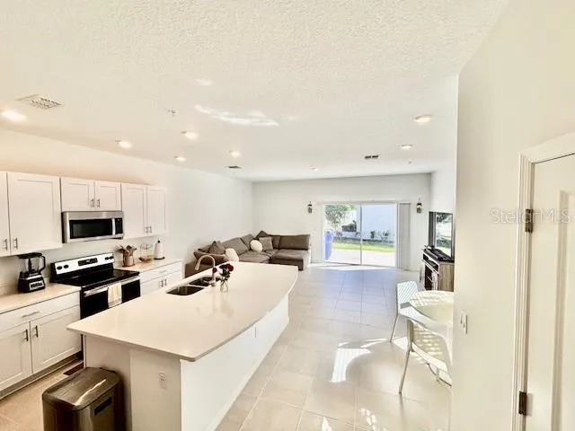 a kitchen with a sink a stove and cabinets