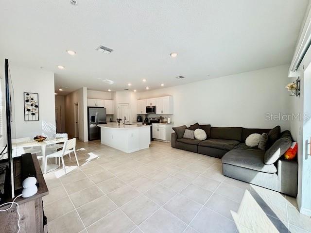 4520 Calvary Way St. Cloud, FL 34769 - Photo 4 of 9 a living room with furniture and kitchen view