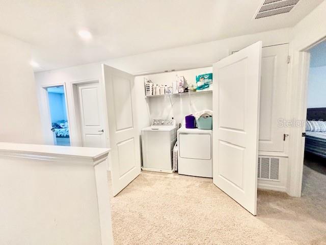 4520 Calvary Way St. Cloud, FL 34769 - Photo 5 of 9 a utility room with cabinets washer and dryer