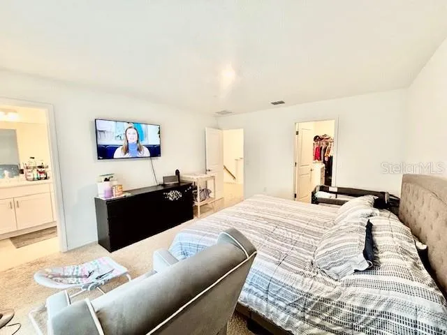 a bedroom with a bed and a couch