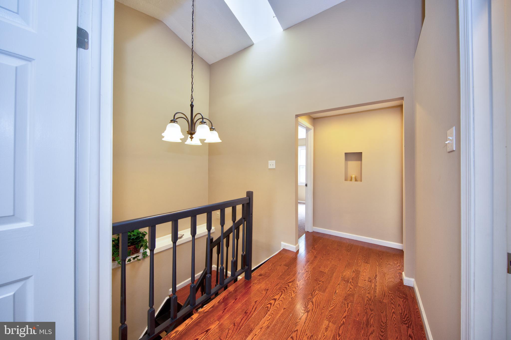 8728 Silver Hall Road Perry Hall, MD 21128 - Photo 16 of 29 Beautiful xtra wide hallway w/ hardwood & skylight