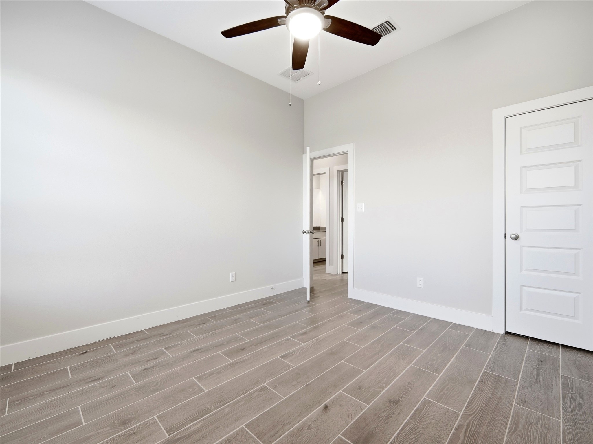 848 Wild Pecan Loop Buda, TX 78610 - Photo 13 of 49 Bright downstairs bedroom with ceiling fan for comfort.