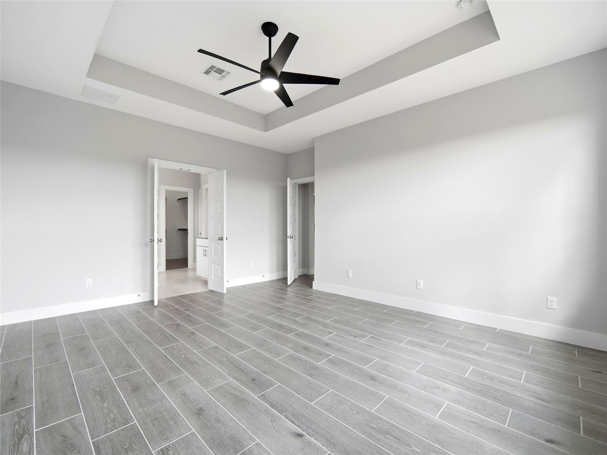 848 Wild Pecan Loop Buda, TX 78610 - Photo 21 of 49 Luxurious master suite with elegant French doors leading to a spacious ensuite bath.