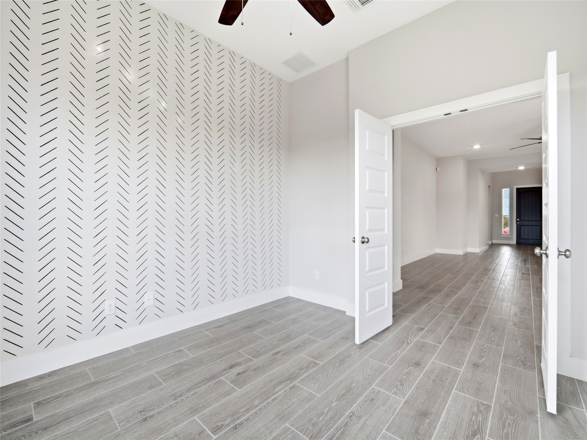 848 Wild Pecan Loop Buda, TX 78610 - Photo 28 of 49 Inviting office/study room with stylish accent wall and ample natural light.