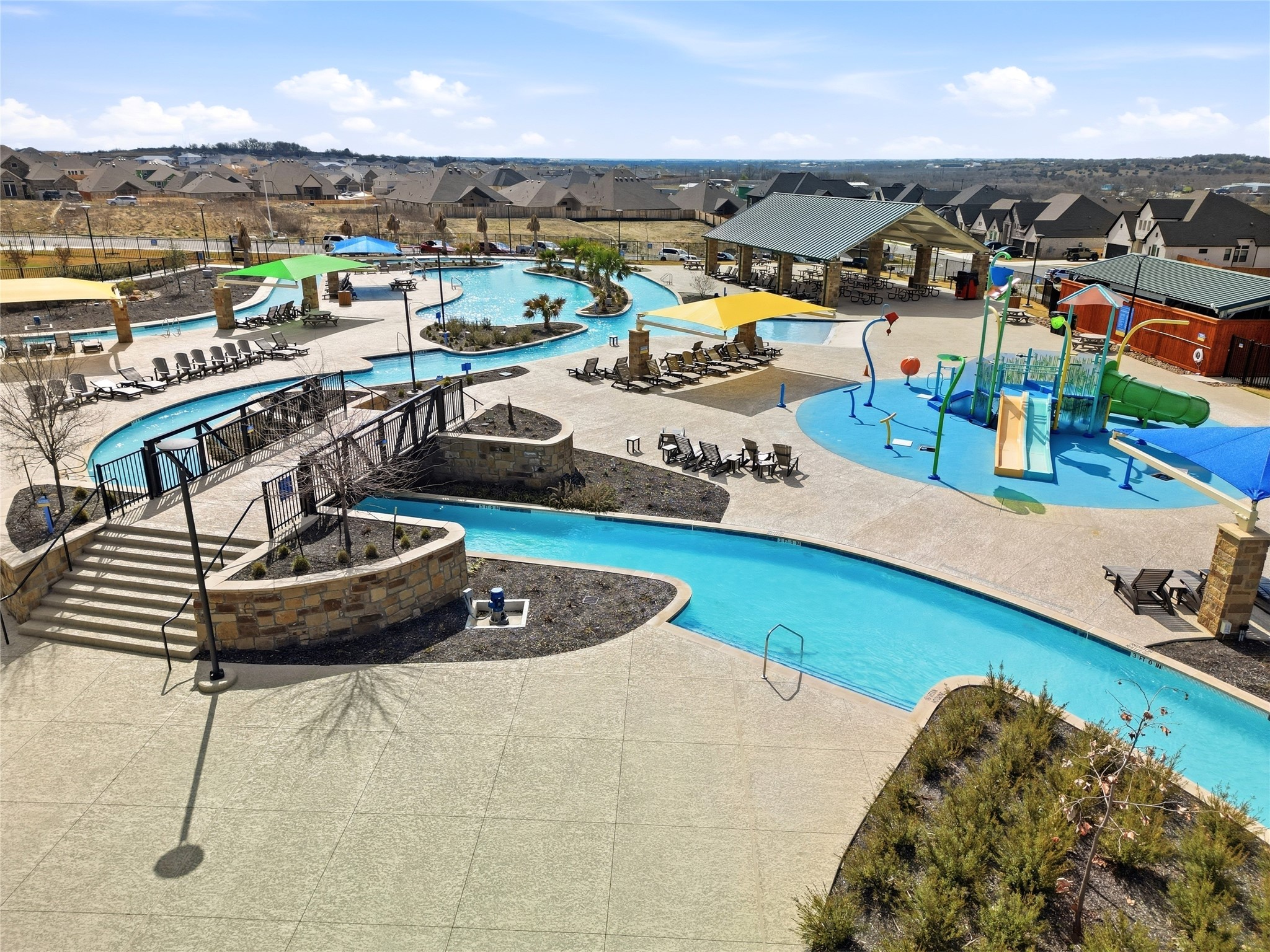 848 Wild Pecan Loop Buda, TX 78610 - Photo 38 of 49 Enjoy resort-style living with a vibrant community pool, featuring a lazy river, splash zone, and ample lounging areas.