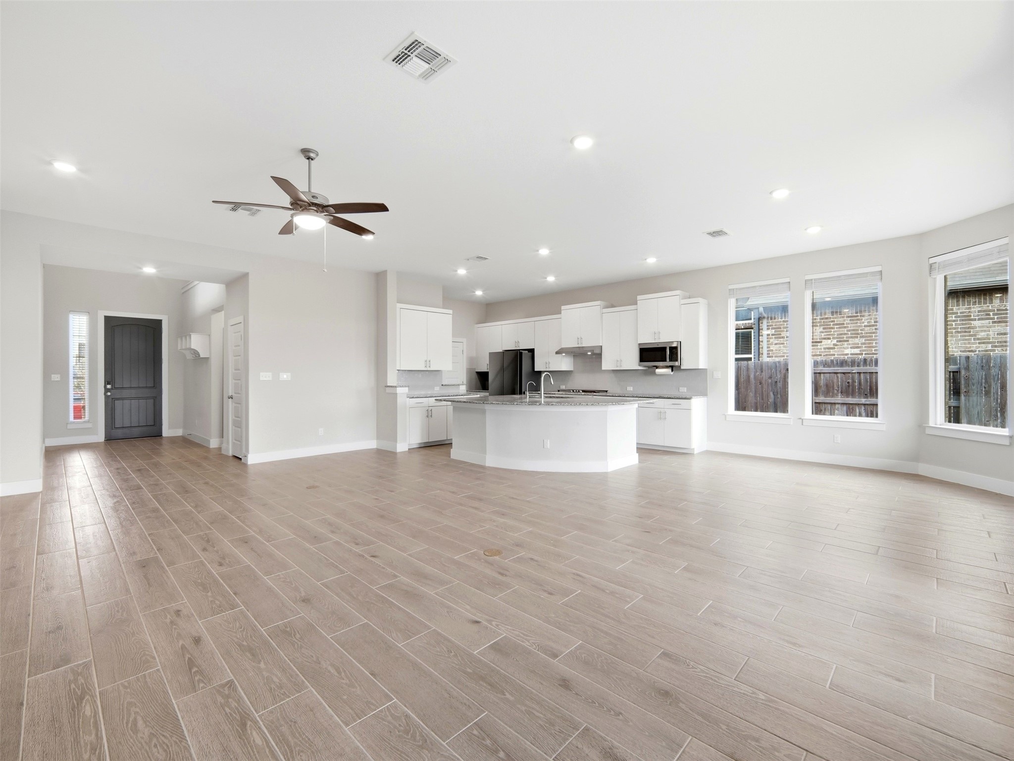 848 Wild Pecan Loop Buda, TX 78610 - Photo 45 of 49 Enjoy a refreshing breeze with the sleek ceiling fan in the spacious downstairs living area.