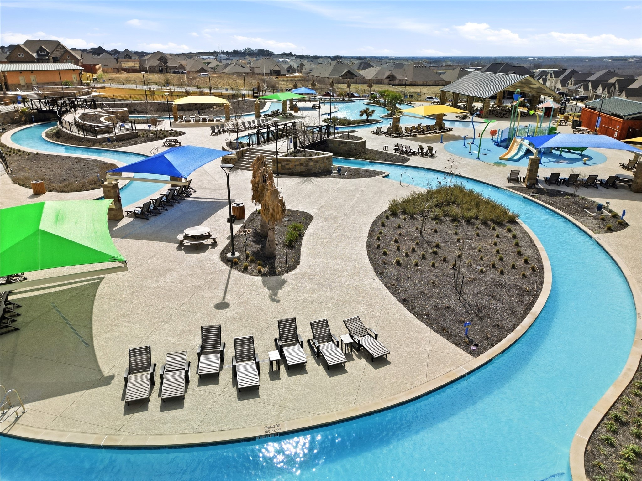 848 Wild Pecan Loop Buda, TX 78610 - Photo 48 of 49 Relax in style at the inviting community pool, complete with comfortable lounge chairs for ultimate leisure.