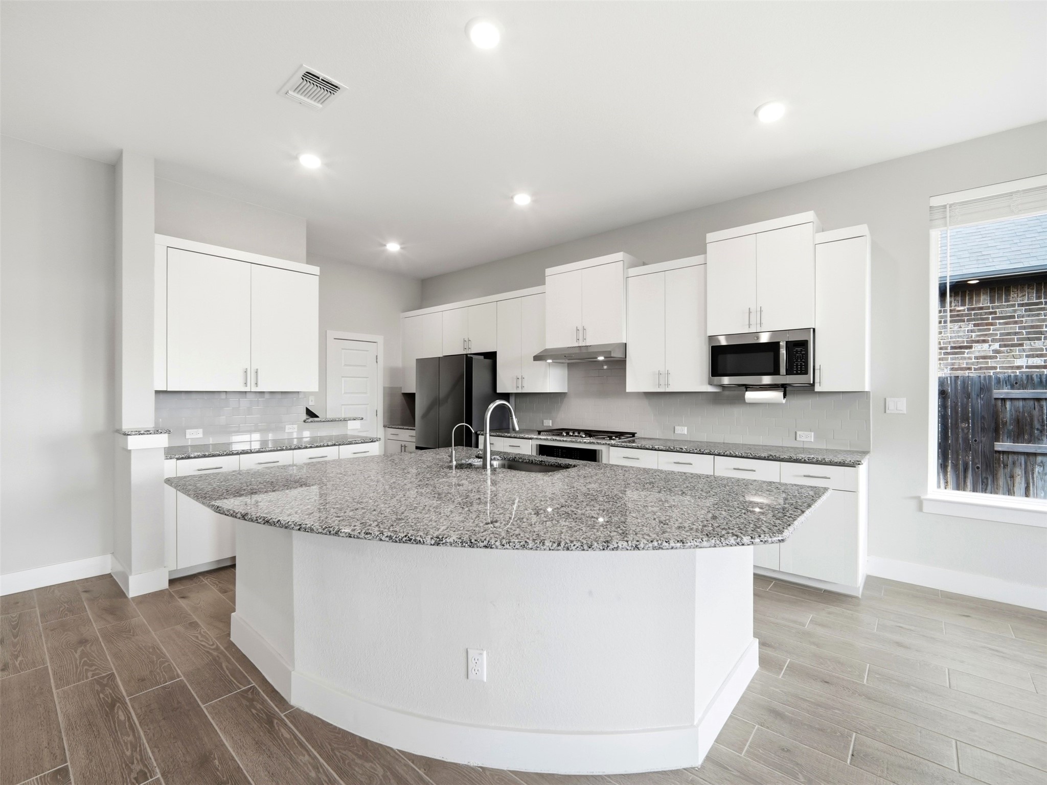 848 Wild Pecan Loop Buda, TX 78610 - Photo 5 of 49 Enjoy a sleek breakfast bar and pure, clean drinking water with the under-sink reverse osmosis system.