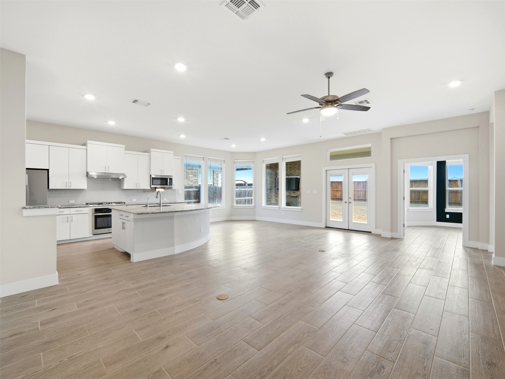 848 Wild Pecan Loop Buda, TX 78610 - Photo 6 of 49 Spacious open-concept living area with abundant natural light and seamless flow for entertaining.