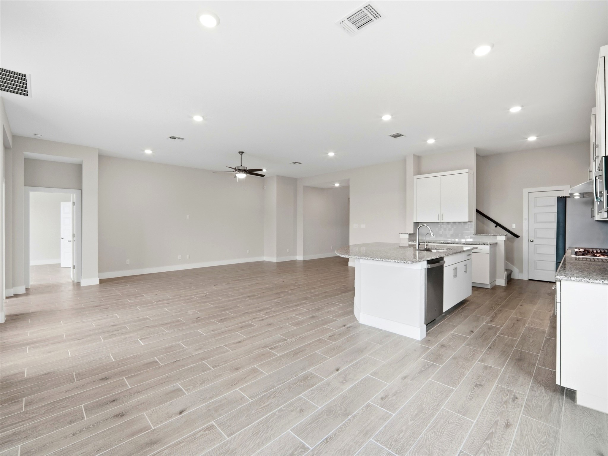 848 Wild Pecan Loop Buda, TX 78610 - Photo 8 of 49 Spacious open-concept living area seamlessly integrates dining, living, and kitchen spaces, perfect for modern living and entertaining.