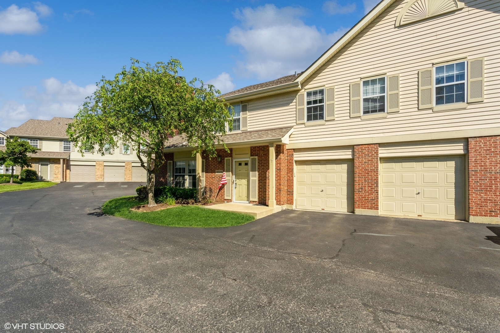 a front view of a house with a yard and garage