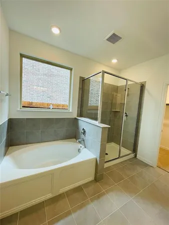 a bathroom with a bathtub and a shower