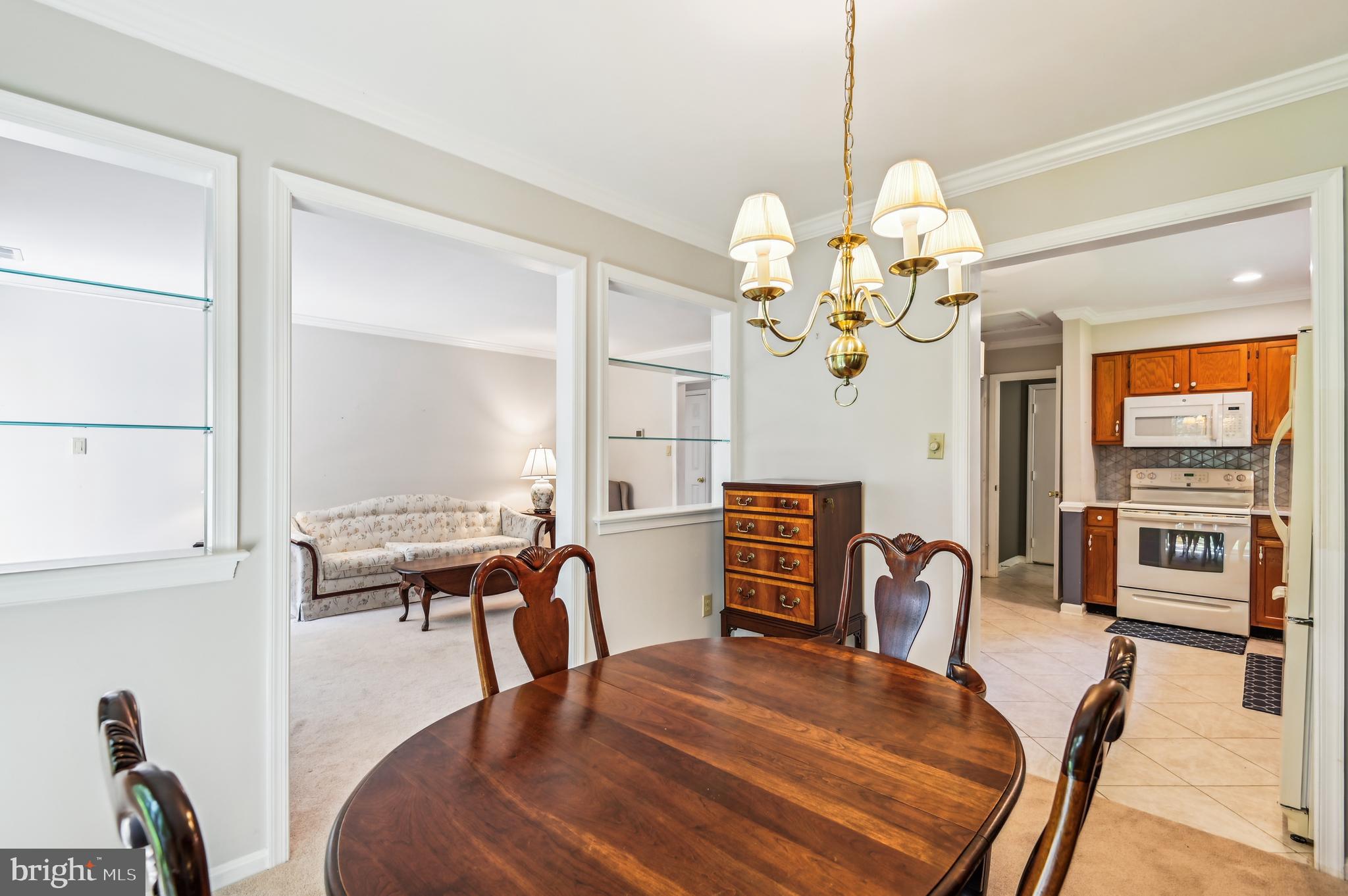 940 Schooner Circle Annapolis, MD 21401 - Photo 14 of 36 a view of a dining room with furniture a chandelier and wooden floor