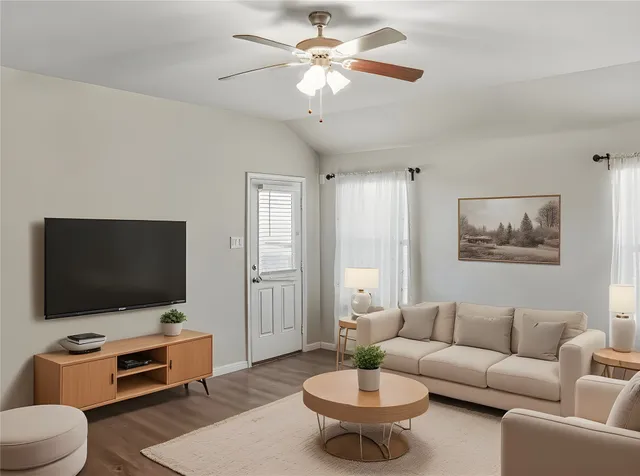 a living room with furniture and a flat screen tv
