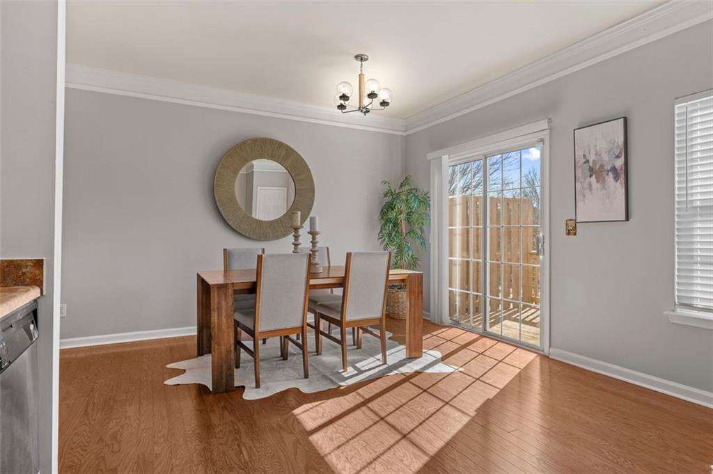 6816 Blackstone Place Mableton, GA 30126 - Photo 13 of 33 a view of a dining room with furniture window and wooden floor