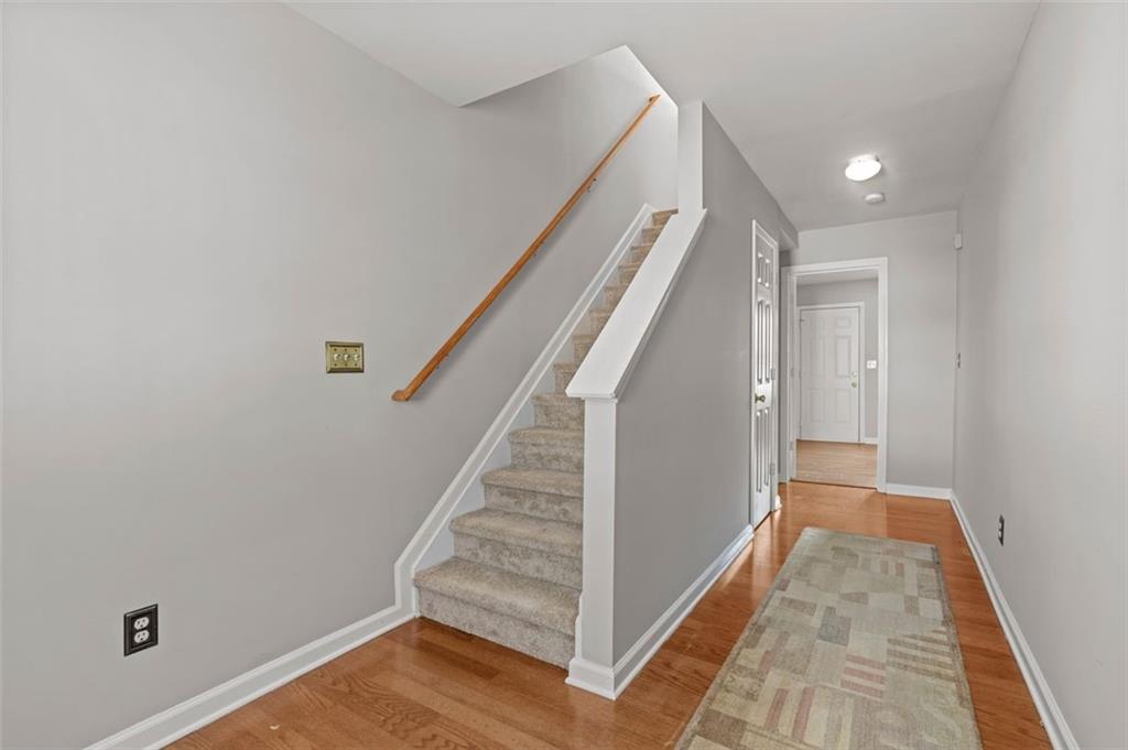 6816 Blackstone Place Mableton, GA 30126 - Photo 15 of 33 a view of a hallway with wooden floor and staircase
