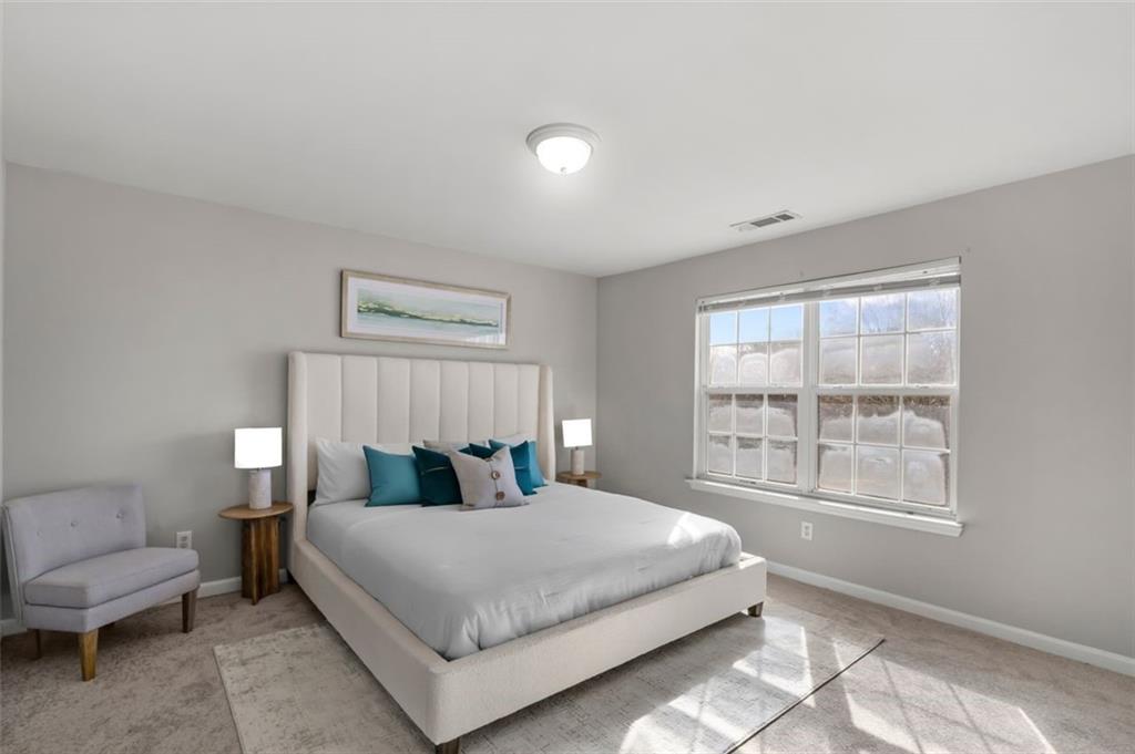 6816 Blackstone Place Mableton, GA 30126 - Photo 19 of 33 a bedroom with a bed and a large window