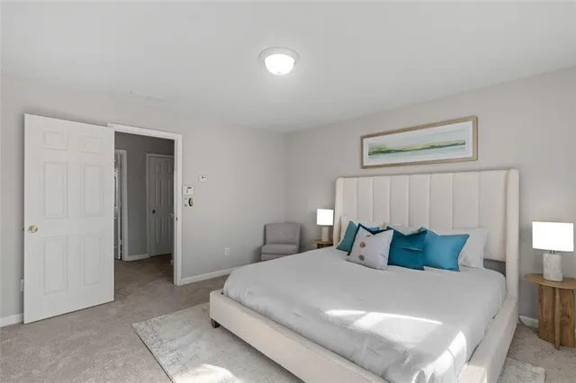 a bedroom with a bed and a night stand