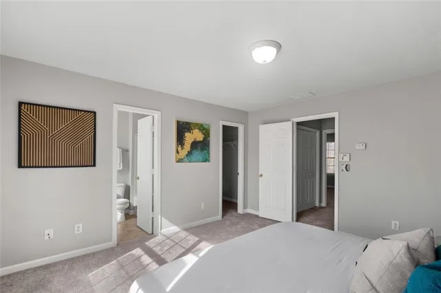 a bedroom with a bed and hallway