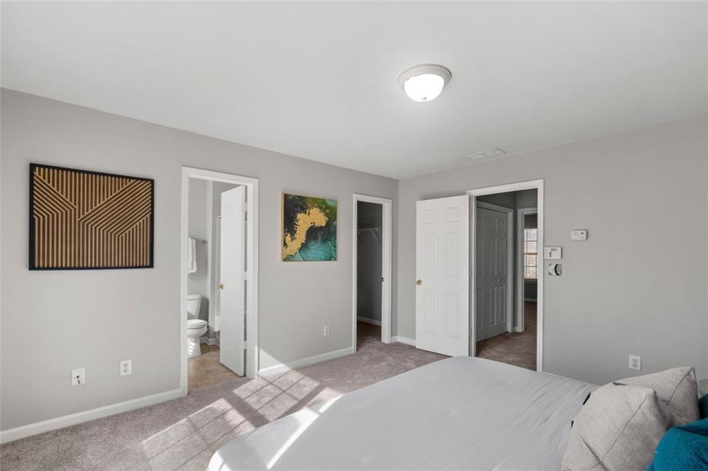 6816 Blackstone Place Mableton, GA 30126 - Photo 21 of 33 a bedroom with a bed and hallway