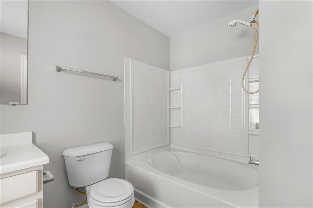 6816 Blackstone Place Mableton, GA 30126 - Photo 26 of 33 a white toilet sitting next to a bath tub