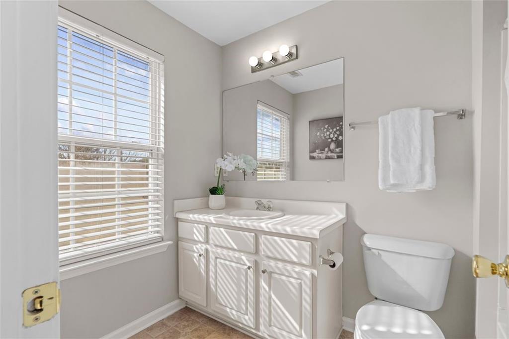 6816 Blackstone Place Mableton, GA 30126 - Photo 27 of 33 a bathroom with a toilet a sink and a window