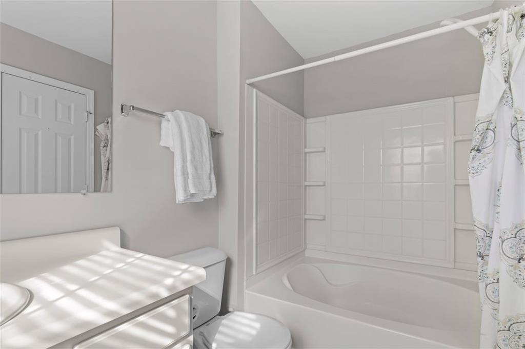 6816 Blackstone Place Mableton, GA 30126 - Photo 28 of 33 a bathroom with a bathtub and a shower