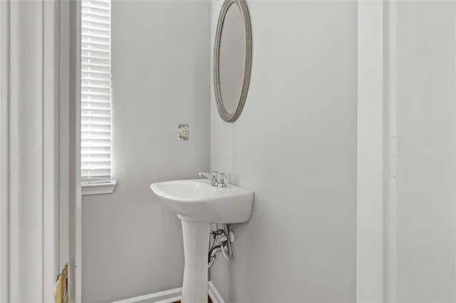 a bathroom with a sink a mirror and a window