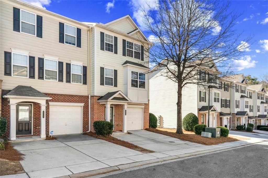 6816 Blackstone Place Mableton, GA 30126 - Photo 3 of 33 a front view of a building with yard and trees